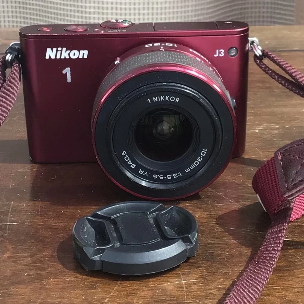 Burgundy Red Nikon 1 J3 high-speed camera with two lenses